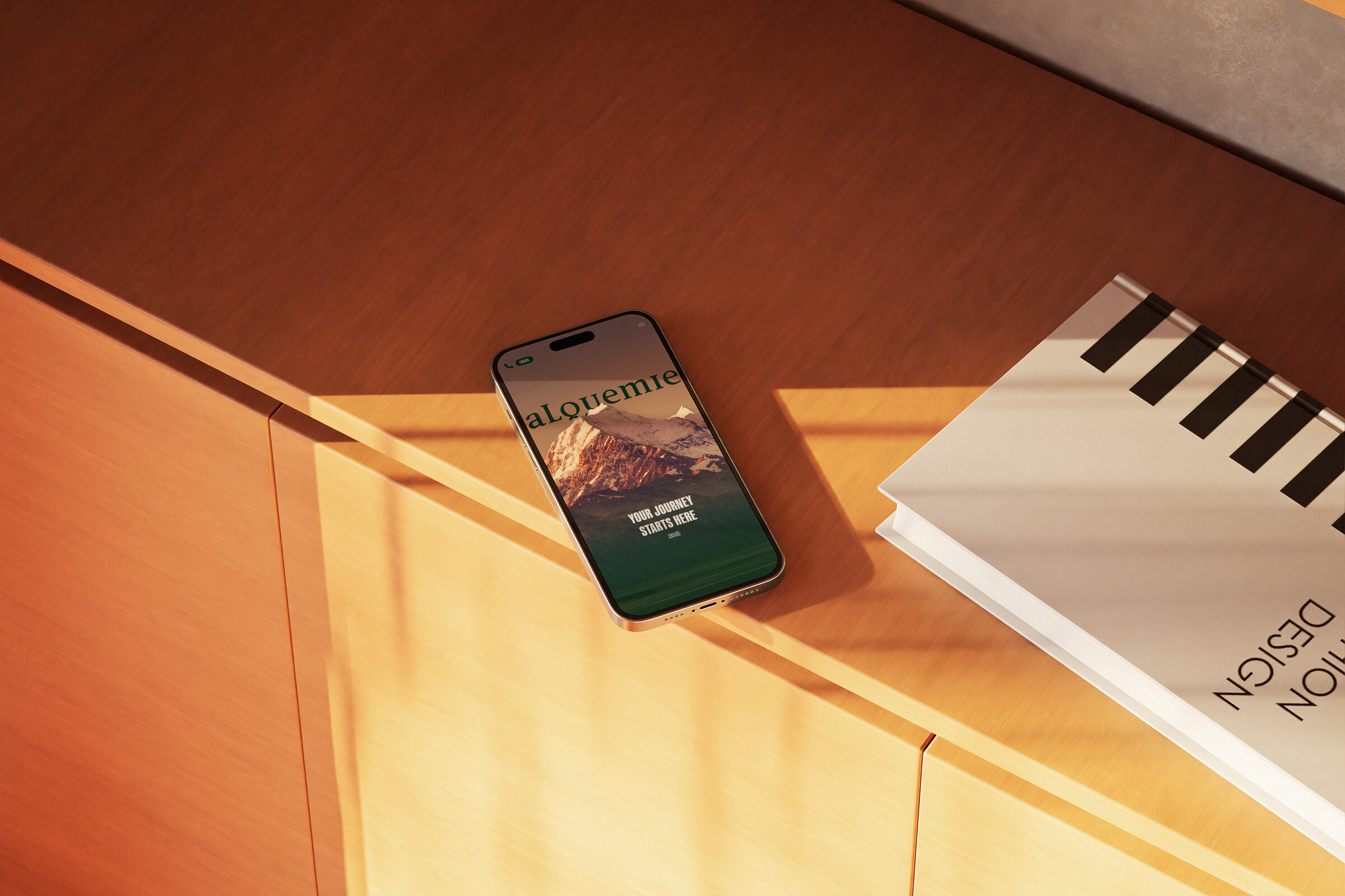 The Alquemie homepage on a phone, the wordmark over the mountains
