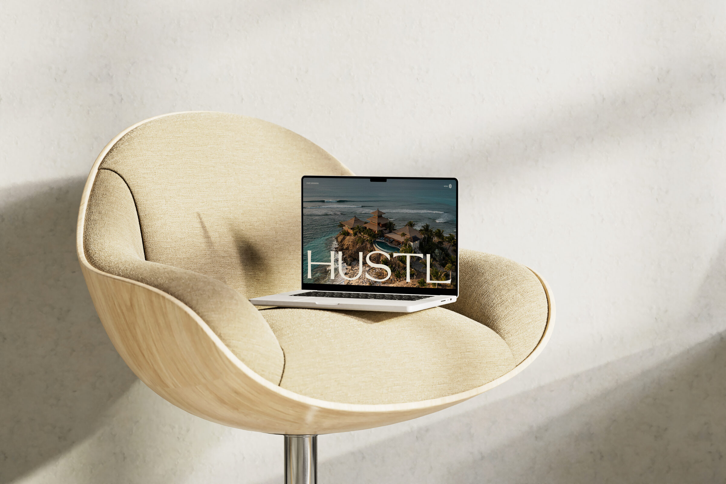 The Hustl website on a laptop, resting on a cream chair