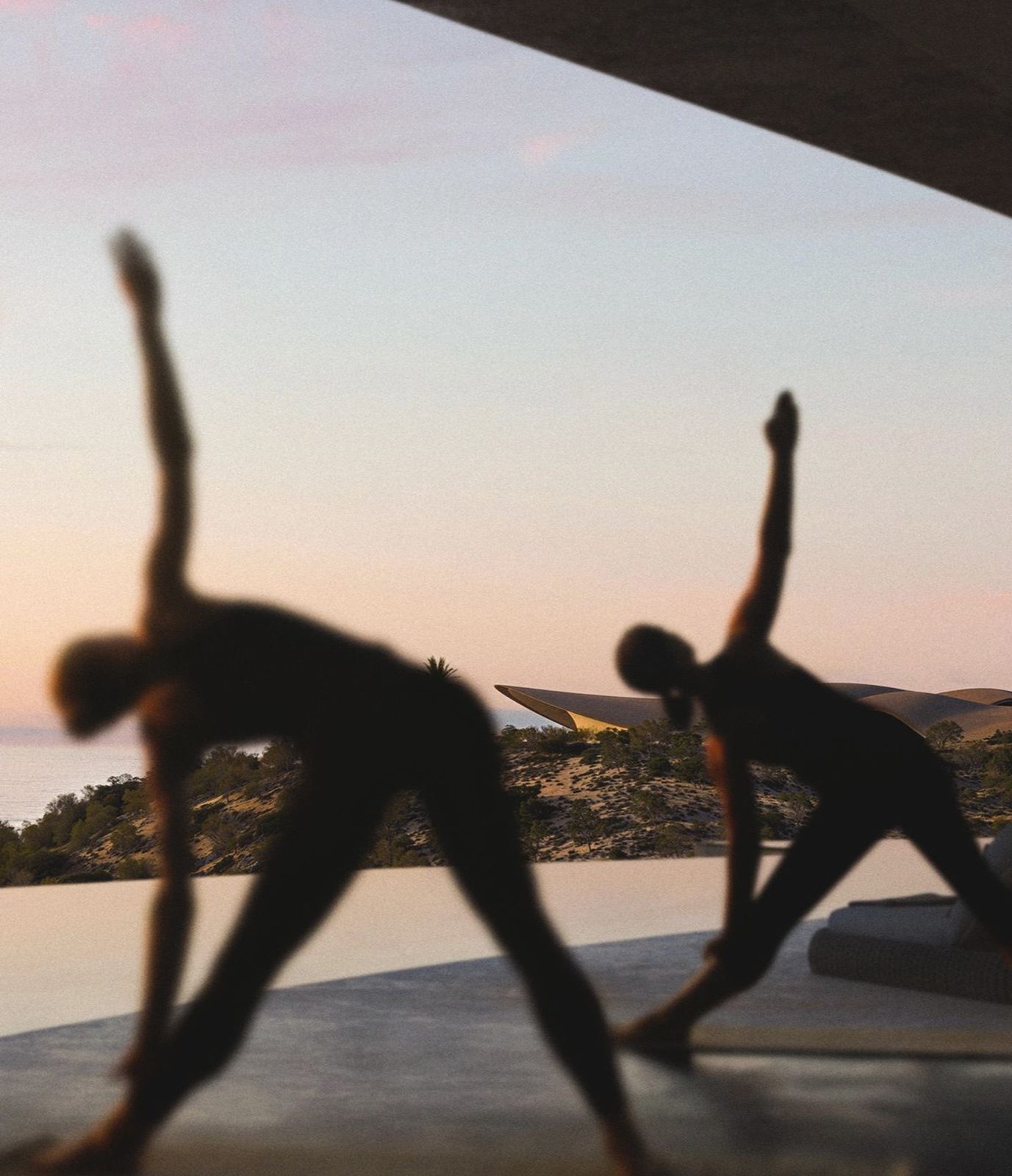 Yoga at dusk by the pool
