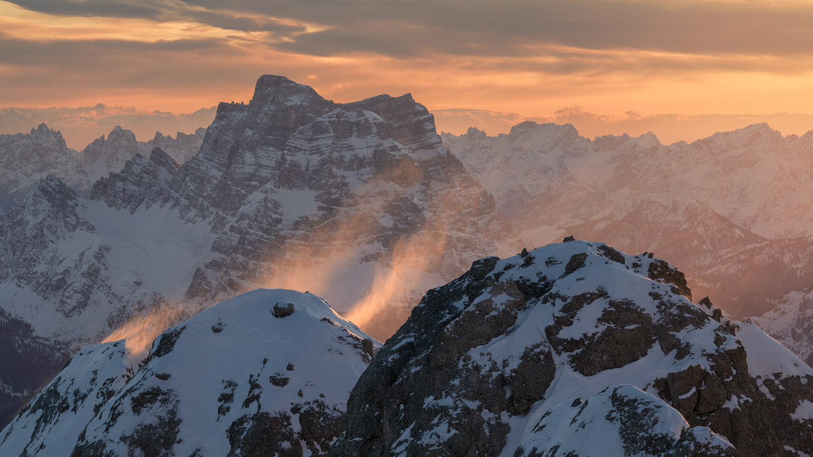 Snow peaks at sunset, cloud lifting off the ridges