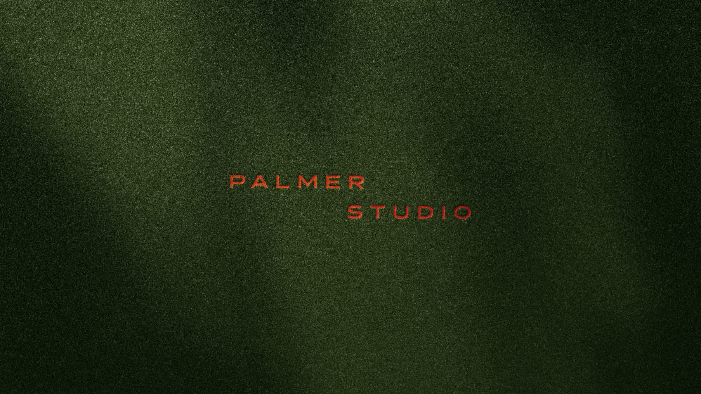 The Palmer Studio logotype printed on deep green paper