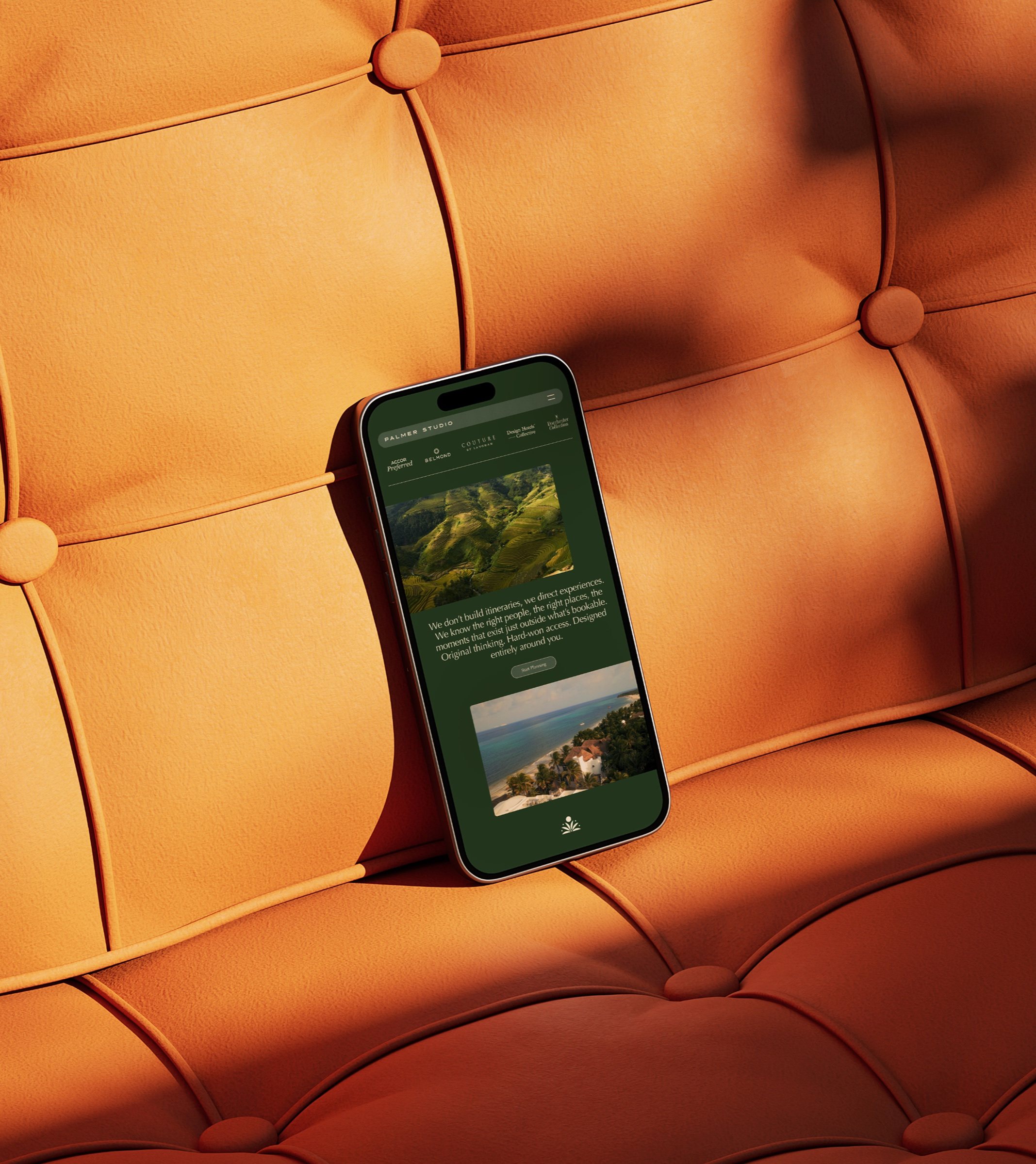 The Palmer Studio website on a phone, resting on a terracotta sofa