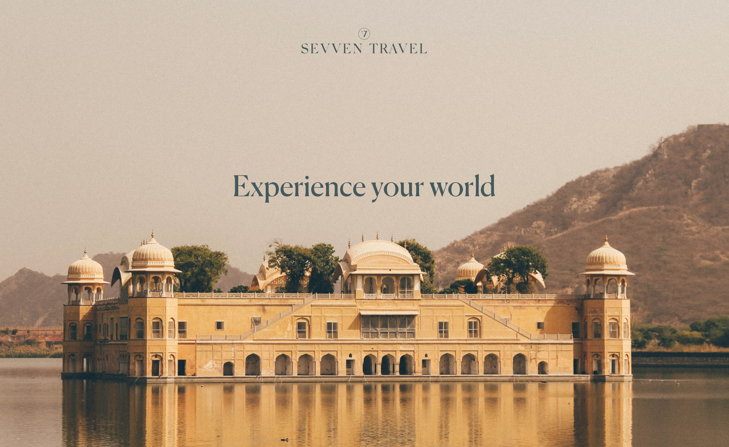 The Sevven Travel wordmark over a lakeside palace at golden hour