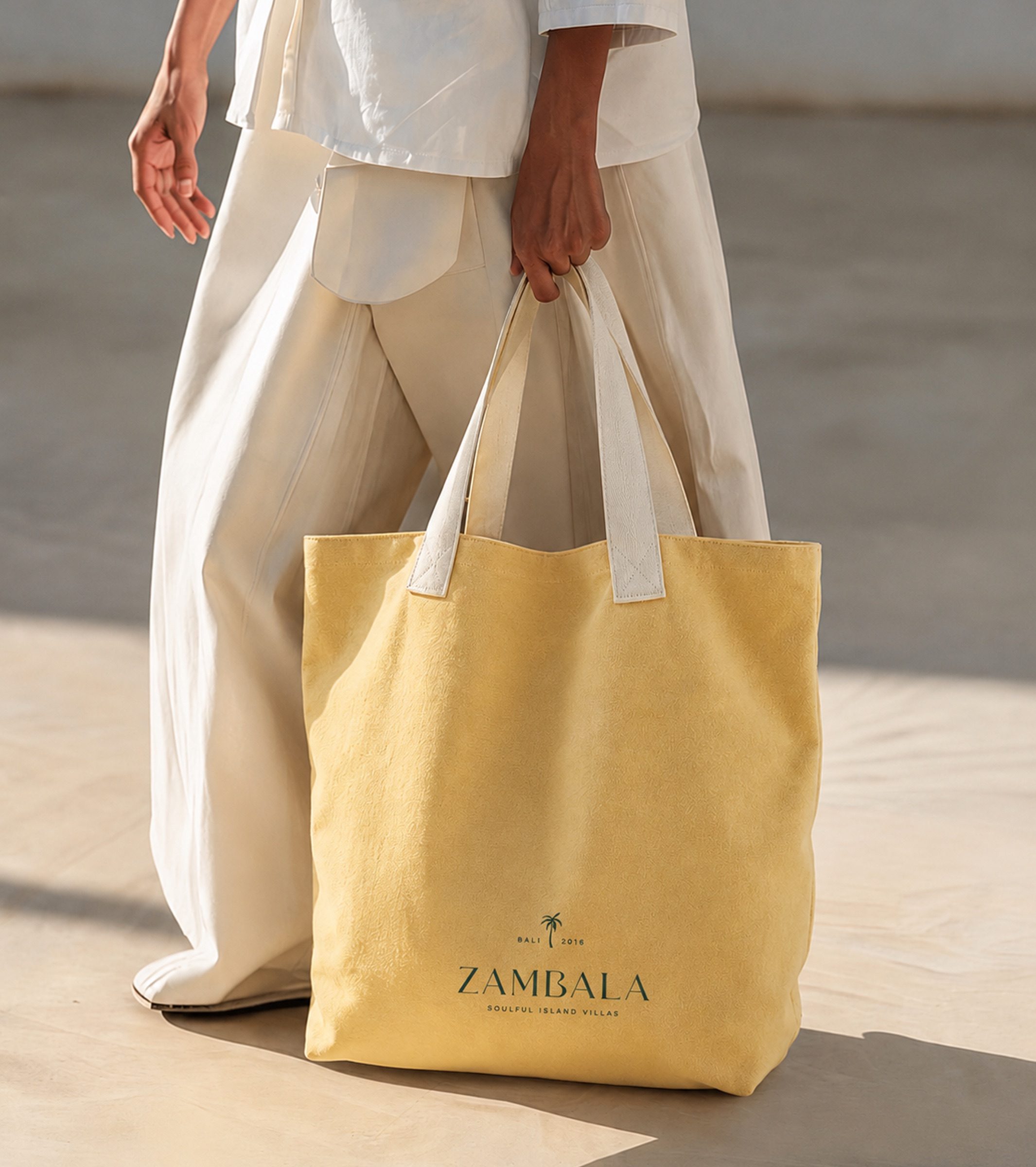The yellow Zambala tote bag, carried in sunlight